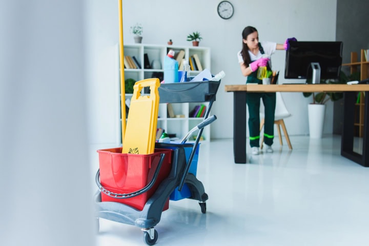 Spring Cleaning Checklist for Commercial Spaces - woman cleaning office