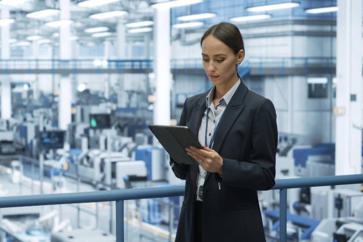 A Facility Manager’s Guide to Spring Readiness - Female Engineer Monitoring and Analyzing Conditions at a Modern Tech Electronics Factory