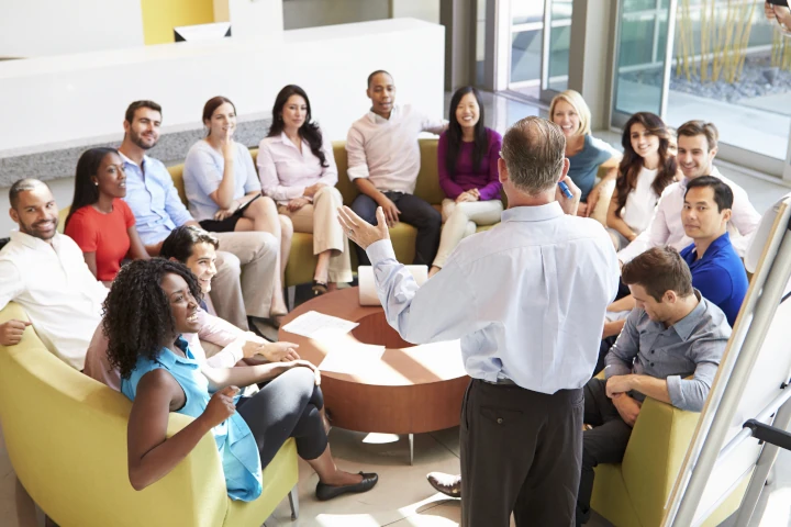 Businessman Making Presentation To Office Colleagues