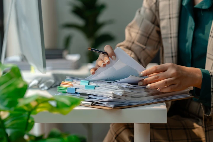 secretary organizing stack of paperwork