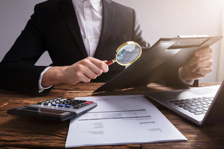 Why Year-End Cleaning Audits Improve Facility Performance – businessman auditing papers Why Year-End Cleaning Audits Improve Facility Performance - businessman auditing papers